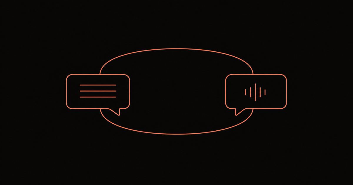 A phone and a notebook on a dark desk, a waveform mid-speech on the phone screen next to handwritten vocabulary notes